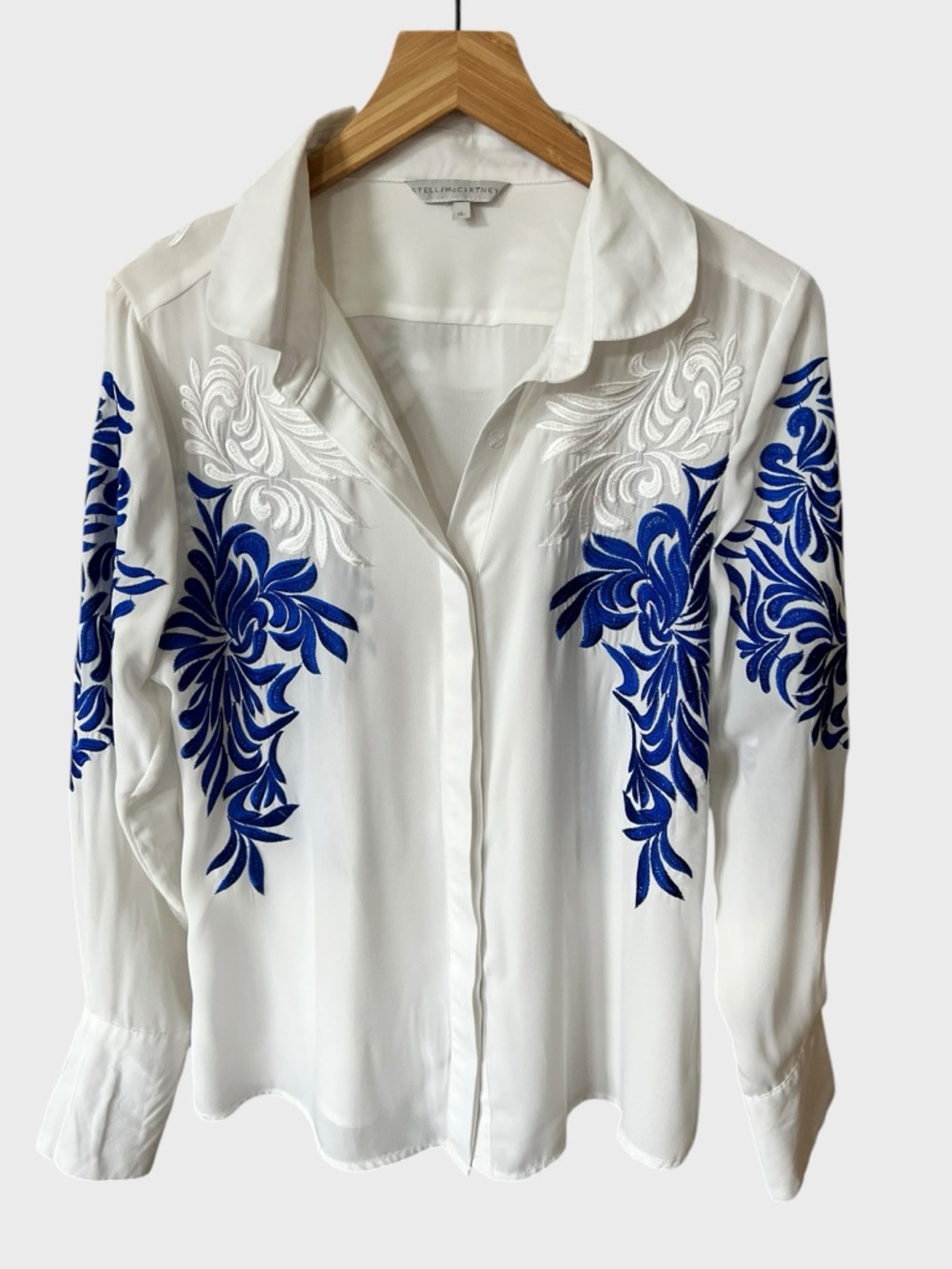 Stella Mc Cartney White Blouse with Blue and White Embroidered Flourish.